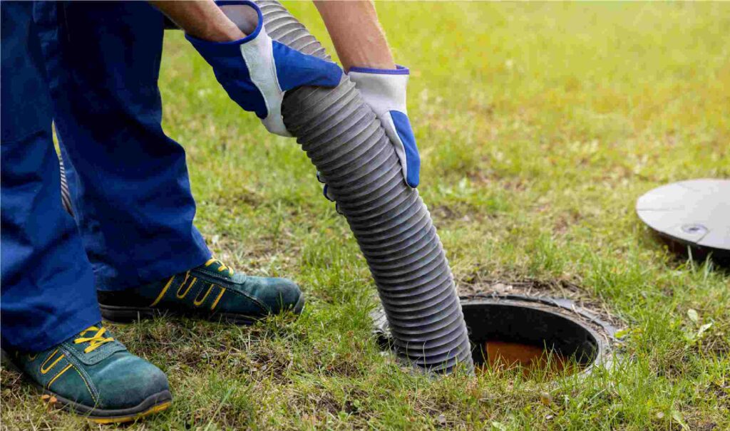 Plumber fixing clogged drain in Wichita home.